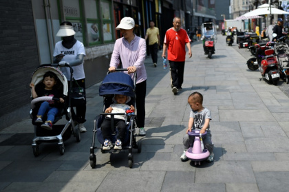 Des femmes avec des poussettes dans une rue de Pékin, le 20 mai 2025 - WANG Zhao (AFP)